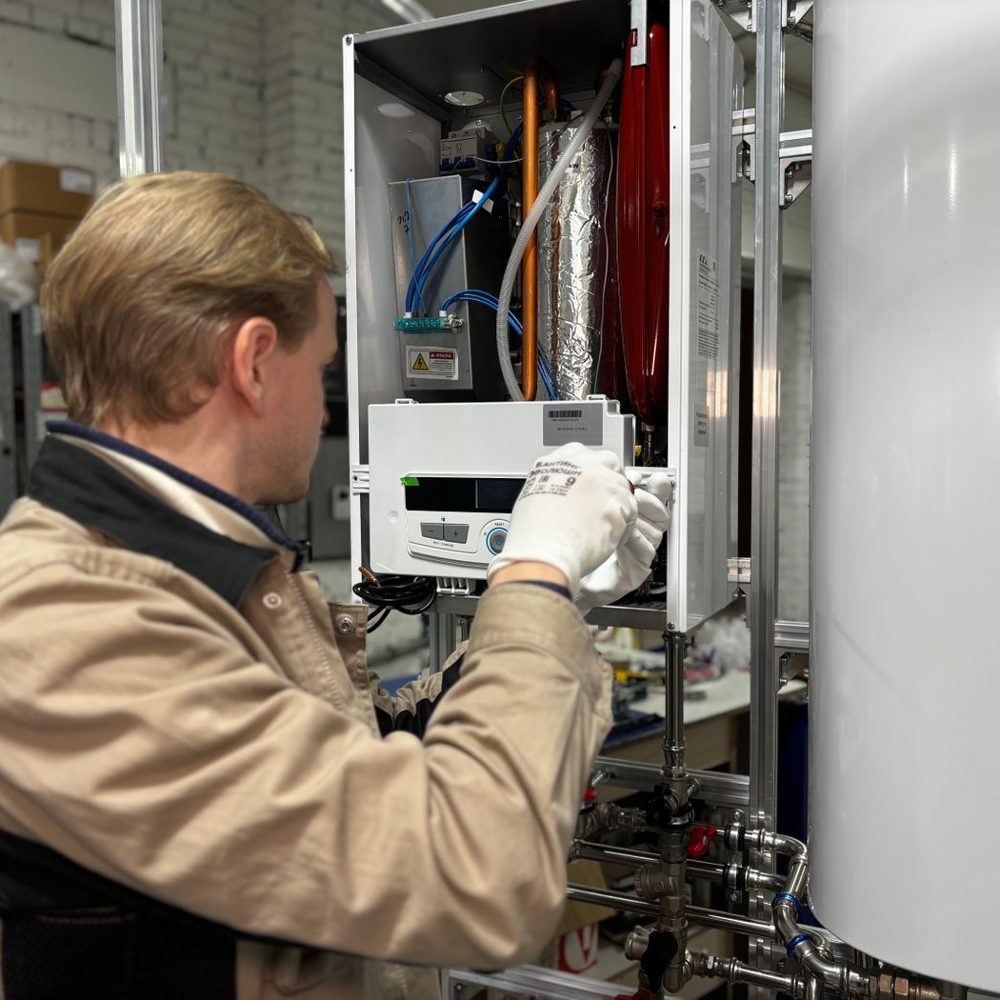 Technician servicing an open tankless water heater