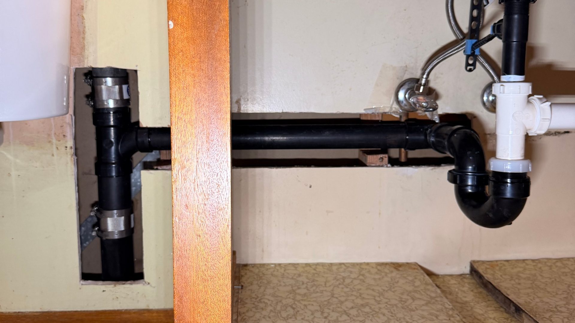 Under-sink supply lines and trap after a Rooster's Plumbing fixture repair